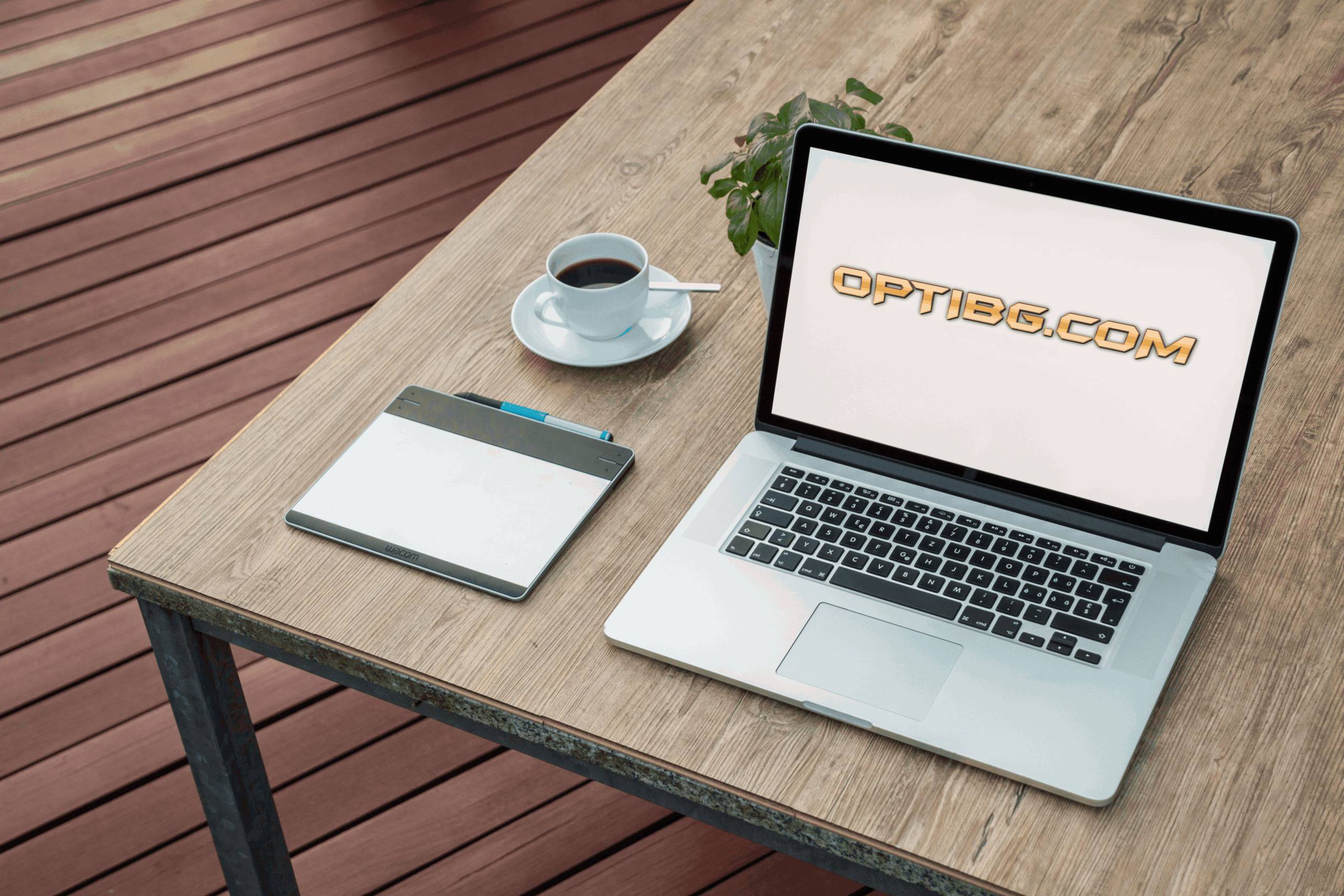 A laptop with the Optibg.com logo on a wooden desk next to a cup of coffee